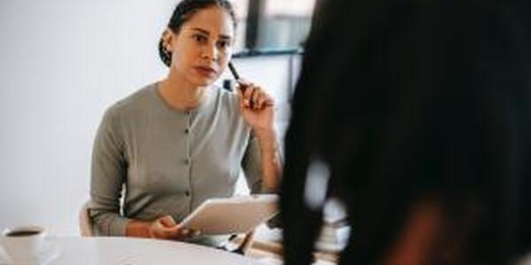 Counselor carefully listening to the concerns of a patient.